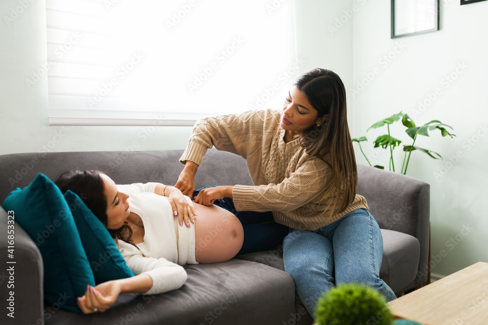 Midwife massaging the hip of an expectant mother Midwife massaging the hip of an expectant mother