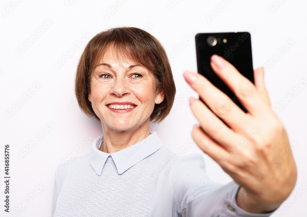 Portrait of her she nice attractive lovely pretty fashionable cheerful senior woman taking making selfie spending free time Portrait of her she nice attractive lovely pretty fashionable cheerful senior woman taking making selfie spending free time