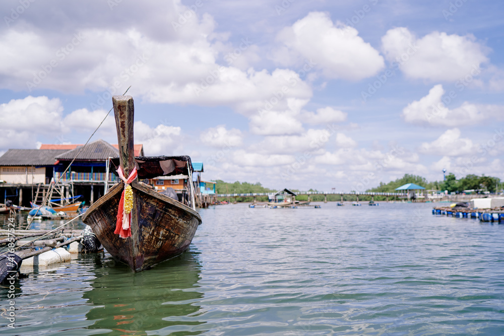 Travel by Thailand. Landscape with traditional longtail boat moored on wharf.