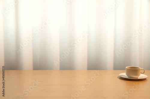 A cup of coffee on the brown desk  white curtain background  copy space