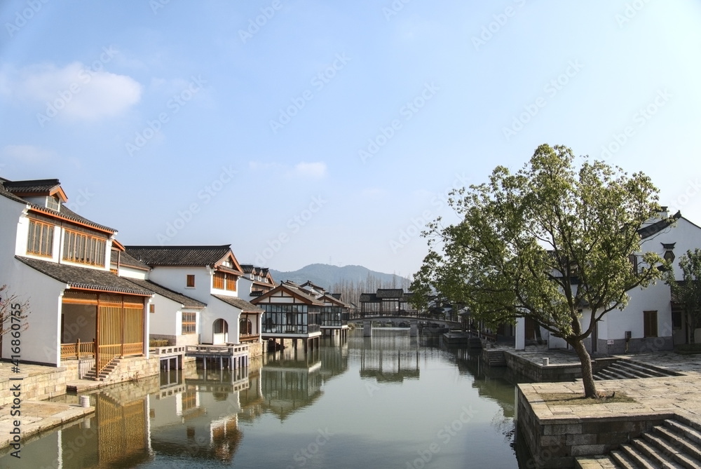 Traditional Chinese houses and reflections on the water surface, sunny weather