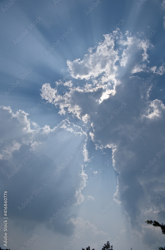 The sun beam passing through the clouds in the sky, vertical The sun beam passing through the clouds in the sky, vertical