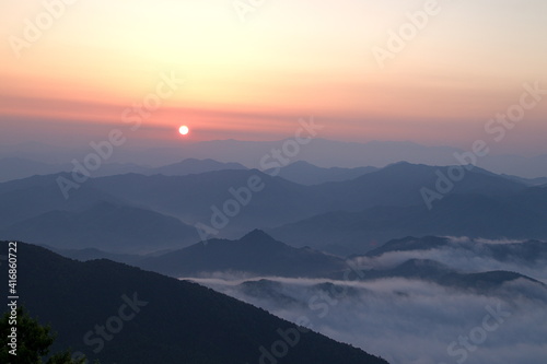 Orange sky background and sea of cloudscape above mountain at sunset  copy space