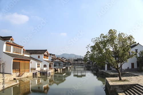 Traditional Chinese houses and reflections on the water surface, sunny weather