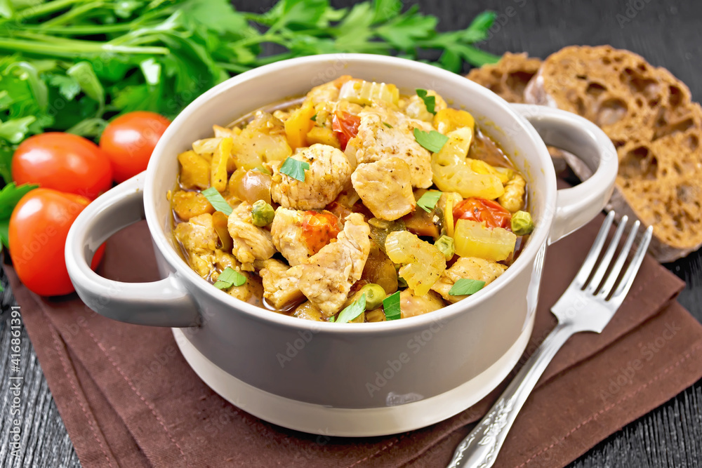 Chicken with vegetables and peas in saucepan on table Chicken with vegetables and peas in saucepan on table