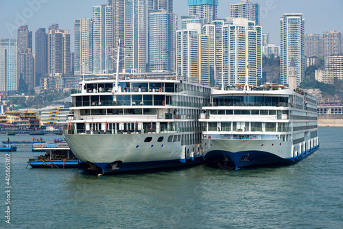 Luxury cruise ships sailing on the Yangtze River, the city skyline in Chongqing, China © onlyyouqj