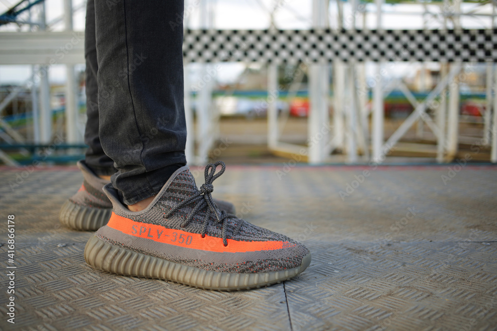 Guy wearing Adidas Yeezy Boost 350 V2 Beluga on a metal surface sneakers  designed by Kanye West, Guadalajara/Mexico - October 12, 2020 foto de Stock  | Adobe Stock