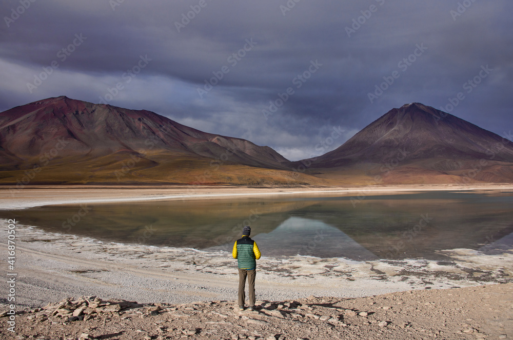 Tourist enjoying the view of Licancabur Volcano and Laguna Verde, Salar de Uyuni, Bolivia