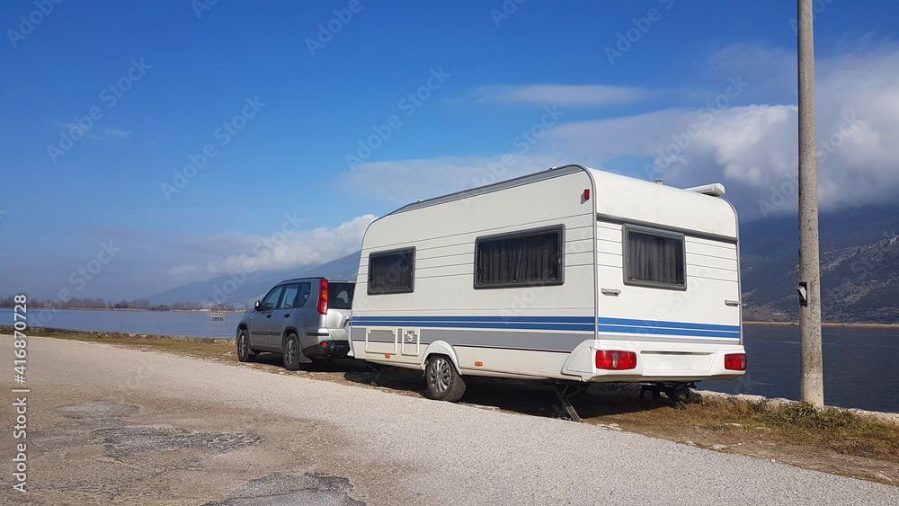 caravan trailer by the lake of Ioannina in winter - obrazy, fototapety, plakaty 