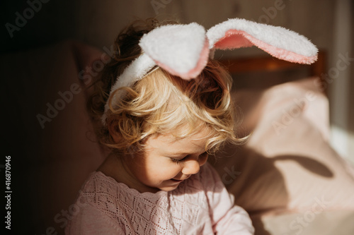 Canvas Print Baby girl wears rabbit ears.