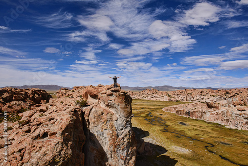 Tourist enjoying the beautiful landscape of hidden Laguna Negra Valley in the Salar de Uyuni, Bolivia