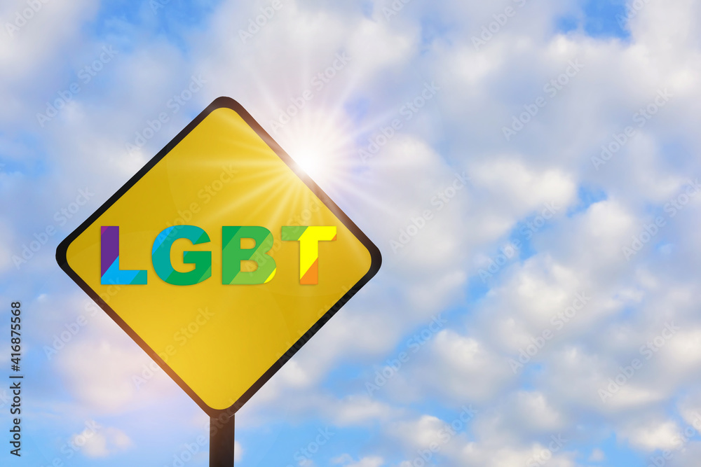 LGBT word on yellow sign on beautiful blue sky with fluffy cloud background. Lesbian gay bisexual transgender concept and equality diversity idea LGBT word on yellow sign on beautiful blue sky with fluffy cloud background. Lesbian gay bisexual transgender concept and equality diversity idea