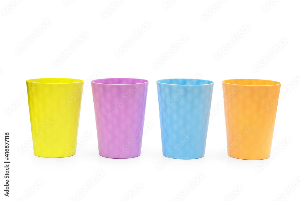 Multicolored plastic glass on a white background. Multicolored plastic glass on a white background.