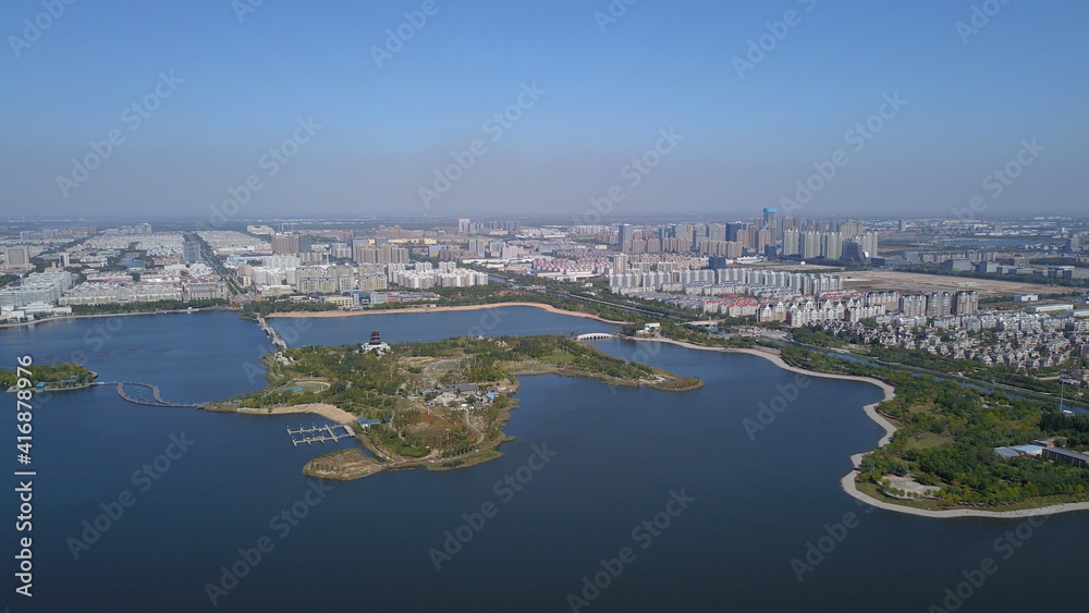 Aerial photography of an island on the lake and city skyline, China