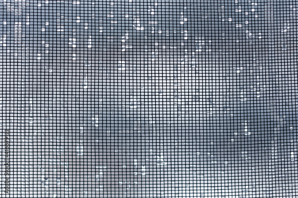 Raindrops on a mosquito net as a background. Raindrops on a mosquito net as a background.