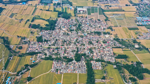 Aerial view of beautiful rural scenery in spring  clean-lined houses and fields on the plain