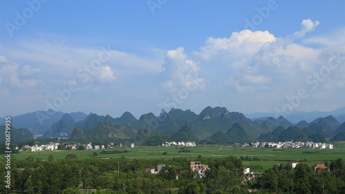 Fields by the mountains under the blue sky; Chinese rural scenery