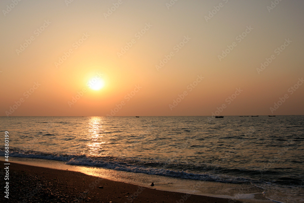 Beautiful sunset with orange sky and shimmering sea