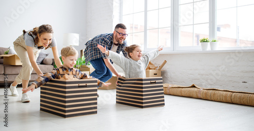 Optimistic family having fun during relocation in new flat