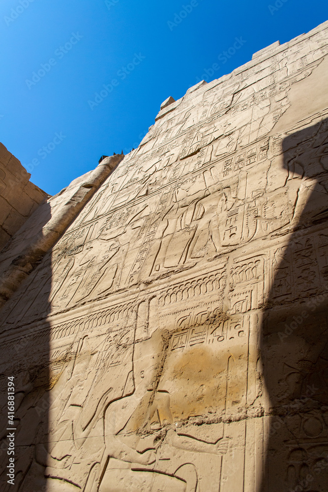 KARNAK TEMPLE - Massive columns inside beautiful Egyptian landmark with hieroglyphics, and ancient symbols. Famous landmark in the world near the Nile River and Luxor, Egypt KARNAK TEMPLE - Massive columns inside beautiful Egyptian landmark with hieroglyphics, and ancient symbols. Famous landmark in the world near the Nile River and Luxor, Egypt