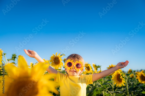 Happy child playing outdoor in spring field