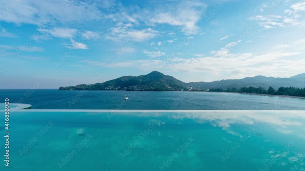 Time Lapse blue sky White clouds flowing over sea with Swimming pool overlooking view andaman sea mountains and clear blue sky background,summer holiday background concept Time Lapse blue sky White clouds flowing over sea with Swimming pool overlooking view andaman sea mountains and clear blue sky background,summer holiday background concept