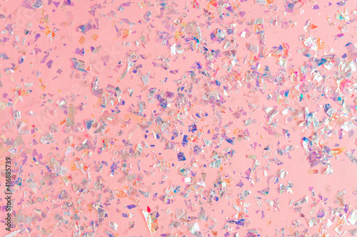 pearl confetti sparkles on pink holiday background. Festive backdrop of sparkles for birthday, carnival