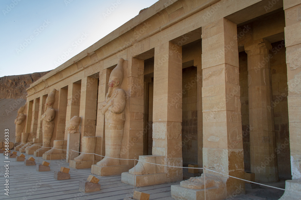 Naklejka premium View of the rocky temple of Hatshepsut. Location of old city Luxor, complex Deir el-Bahari, Egypt, Africa. Popular touristic place. Ancient Egyptian civilization. Discover the beauty of earth.