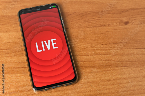 Phone with Live stream logo on table