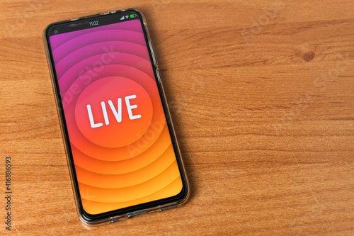 Phone with Live stream logo on table
