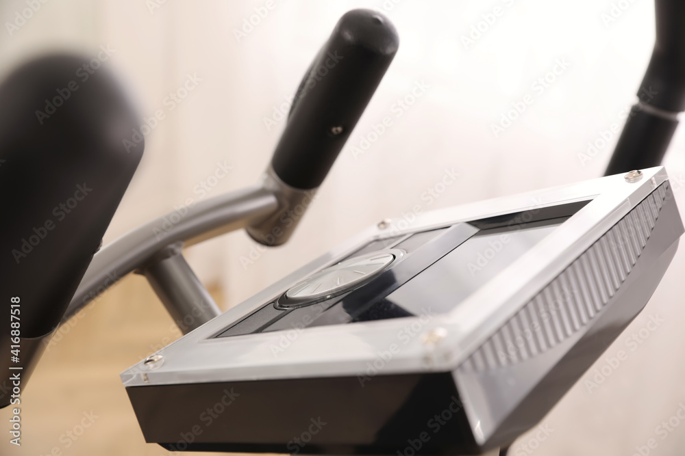 Control panel of modern elliptical machine cross trainer on blurred background, closeup Control panel of modern elliptical machine cross trainer on blurred background, closeup