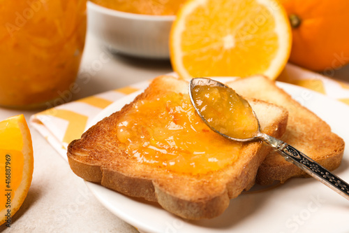 Canvastavla Delicious toasts with orange marmalade on table, closeup