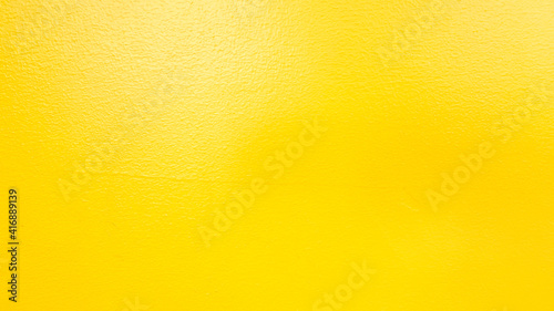 Texture of the yellow cement wall for background
