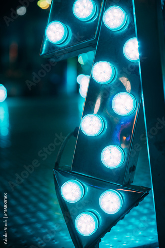 Close-up of teal Neon lights at fair.