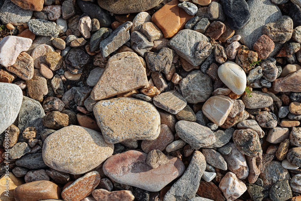 Large and small stones and pebbles. Stone shore. Background or wallpaper. 