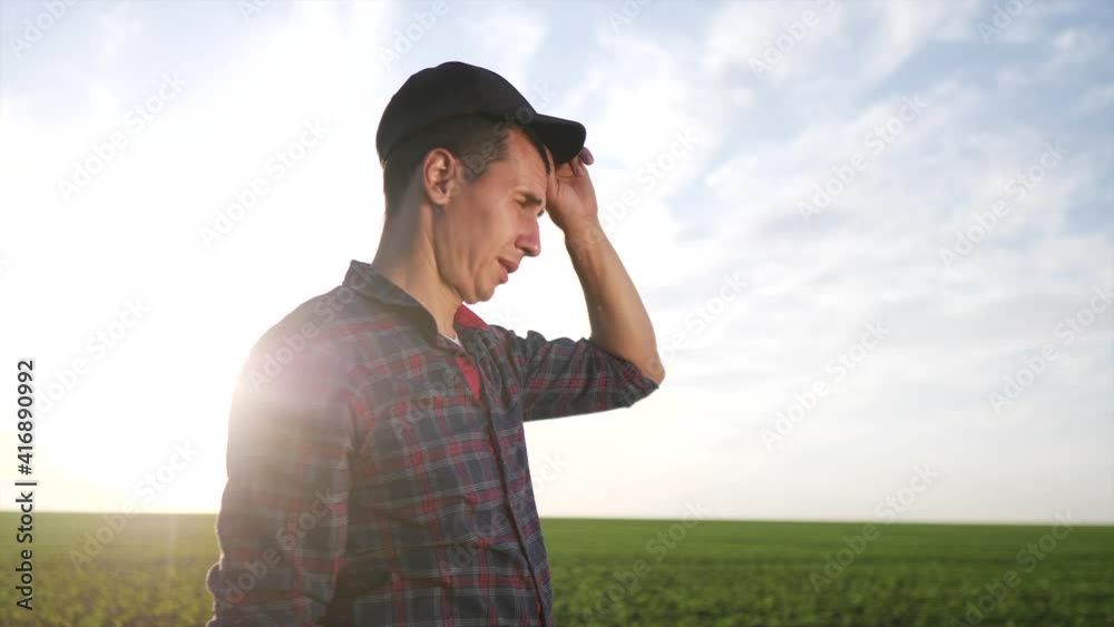agriculture. farmer face portrait in field at harvest. agribusiness agriculture a harvesting crop concept. working farmer portrait stands in the field resting during the harvest agriculture. farmer face portrait in field at harvest. agribusiness agriculture a harvesting crop concept. working farmer portrait stands in the field resting during the harvest