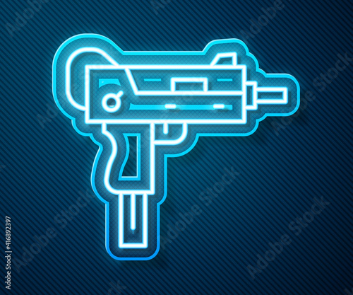 Glowing neon line UZI submachine gun icon isolated on blue background. Automatic weapon. Vector.
