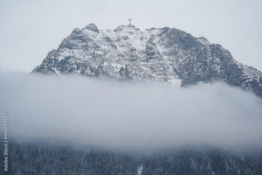 Caraiman Cross on a foggy winter day, Busteni, Romania.