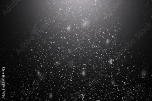 Snowfall on black background, an abstract background
