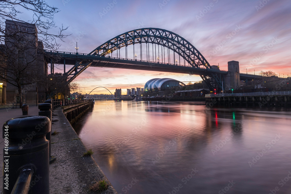 Colourful clouds glow at sunrise over the Tyne Bridge on February 27, 2021