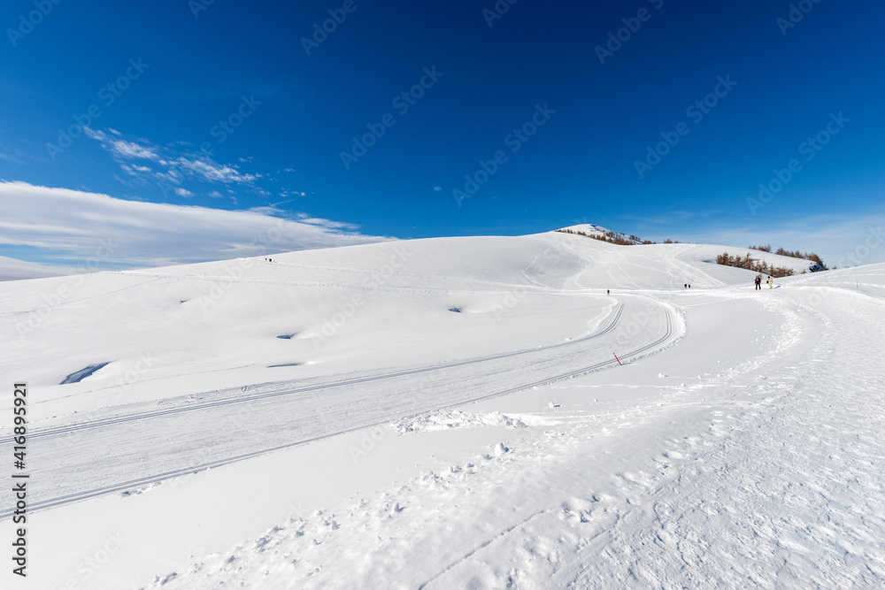 Cross-Country Skiing Tracks and footpath with snow in winter. Altopiano della Lessinia (Lessinia Plateau), Regional Natural Park, near Malga San Giorgio, ski resort in Verona province, Veneto, Italy.
