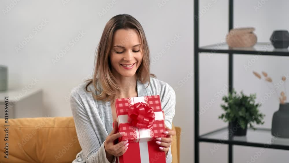Portrait cute smiling lady opening festive red gift box posing rejoicing. Shot with RED camera in 4K Portrait cute smiling lady opening festive red gift box posing rejoicing. Shot with RED camera in 4K