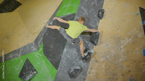 Man training for a climbing competition exercises at a closed training center.