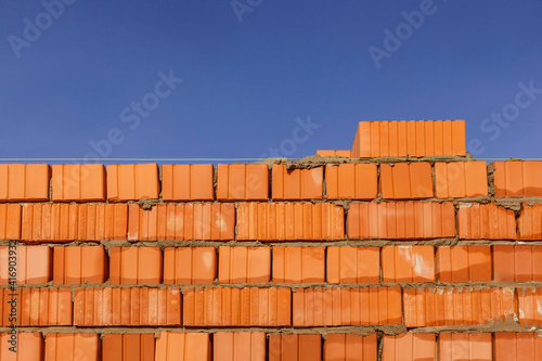 Brick wall on a background of blue sky
