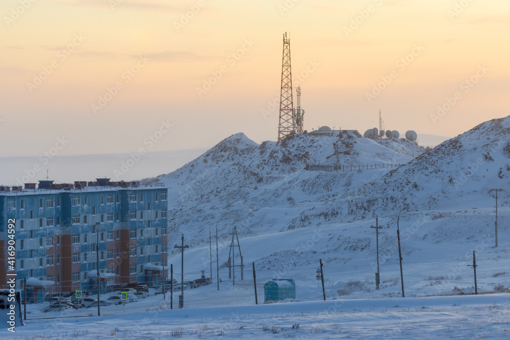TV tower and satellite dishes on top of the mountain. Arctic industrial landscape. Telecommunications, digital television and the Internet in the Far North in the Arctic. Anadyr city, Chukotka, Russia TV tower and satellite dishes on top of the mountain. Arctic industrial landscape. Telecommunications, digital television and the Internet in the Far North in the Arctic. Anadyr city, Chukotka, Russia