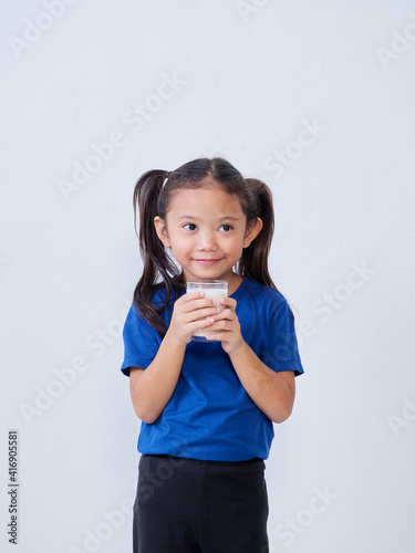 Little girl with glass of milk