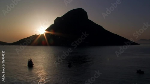 Kalymnos Telendos time-lapse of the island at sunset with fishing boats photo