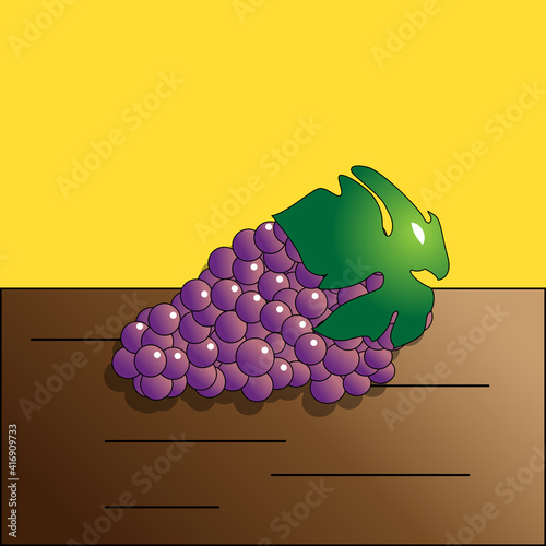Purple grape on a brown table with green leaf on a yellow background.