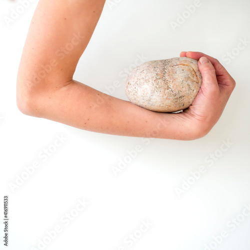 Hand holding a stone close up