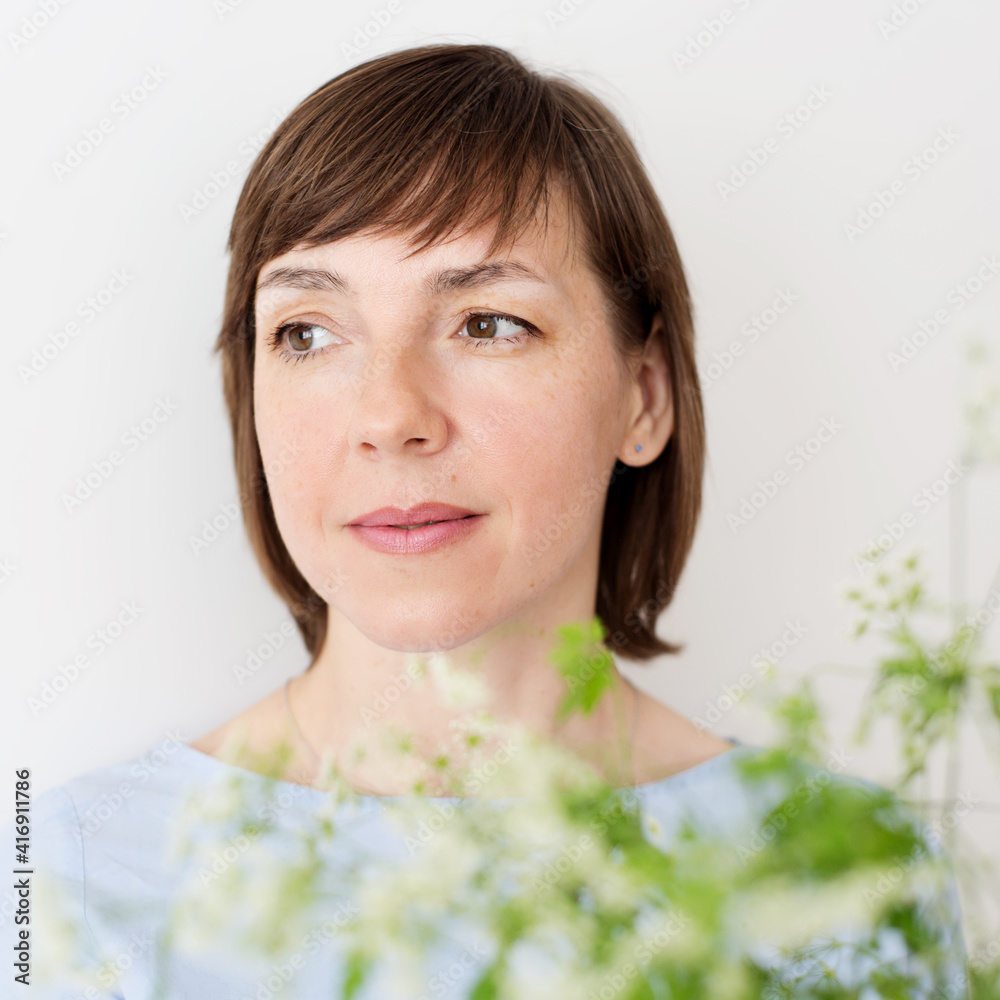 Portrait of woman with short hair near green plant close up Portrait of woman with short hair near green plant close up